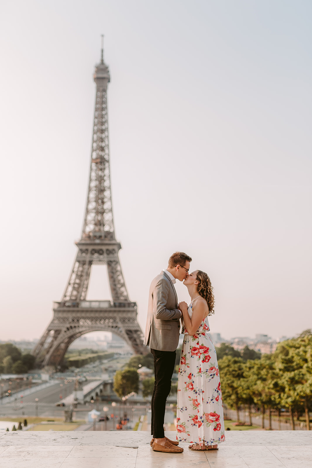 Couple kisses in front of the Eiffel Tower during their Wanderlust Engagement Session in Paris. Photo by Victoria Heer, luxury wedding photographer.