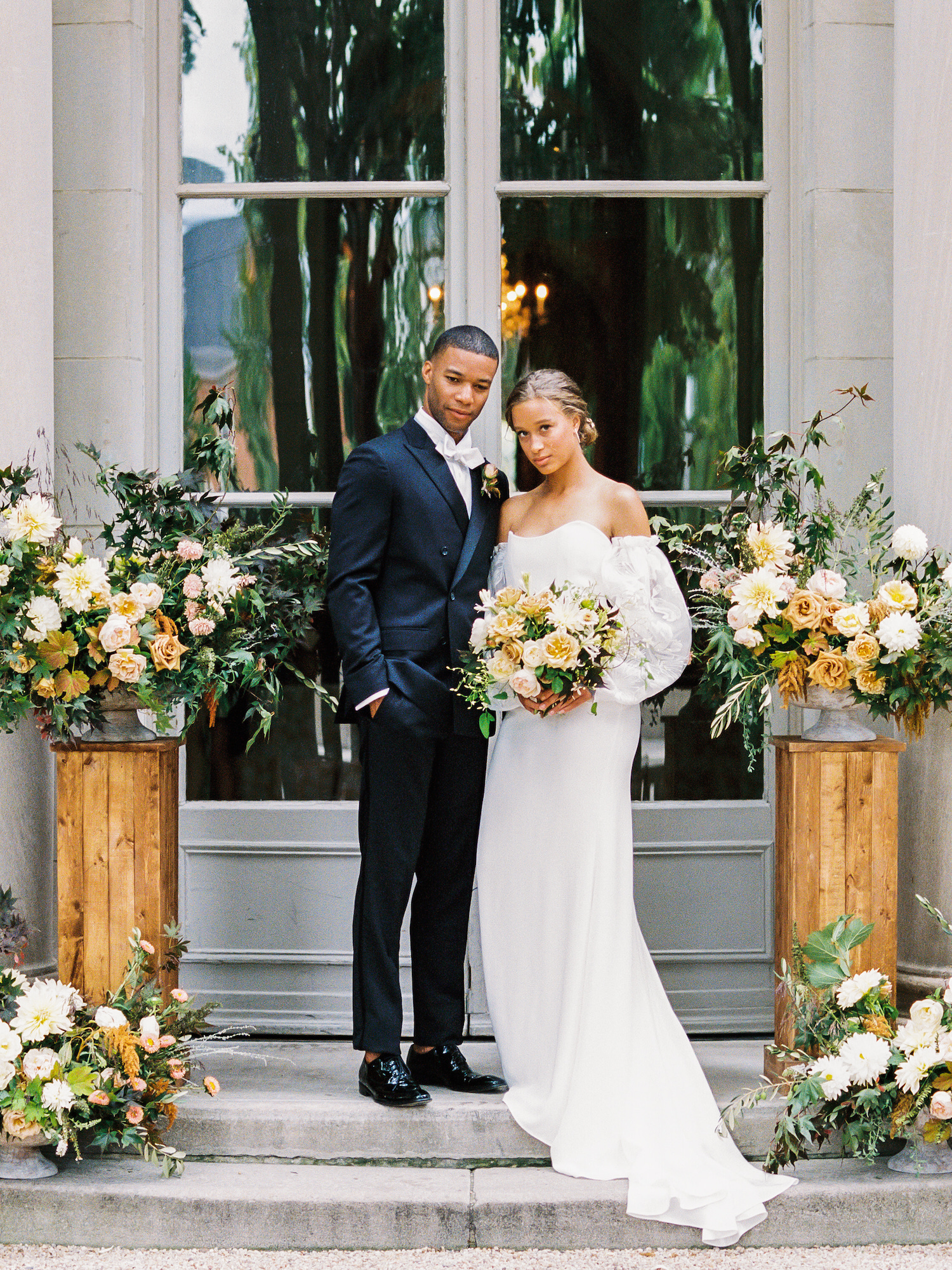 A bride and groom pose in front of one of the top 9 luxury wedding venues in Washington DC. Image by Victoria Heer, fine art wedding photographer.